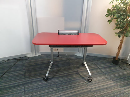 Foldable office desk with open cable port, right, tall green plant
