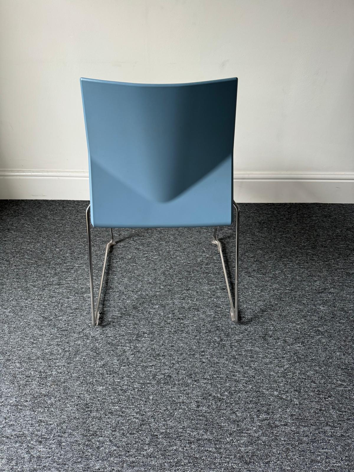 Back of blue chair on silver chrome legs