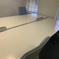 White office table and blue armless desk chairs