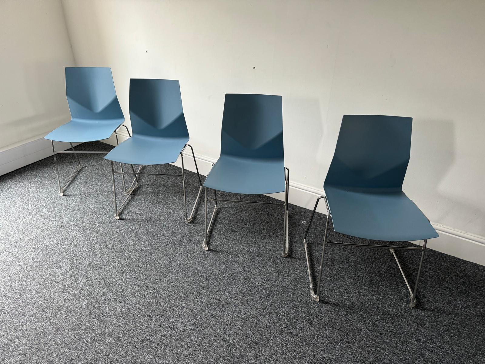 Four blue plastic chairs linear