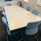 White meeting table and blue padded chairs