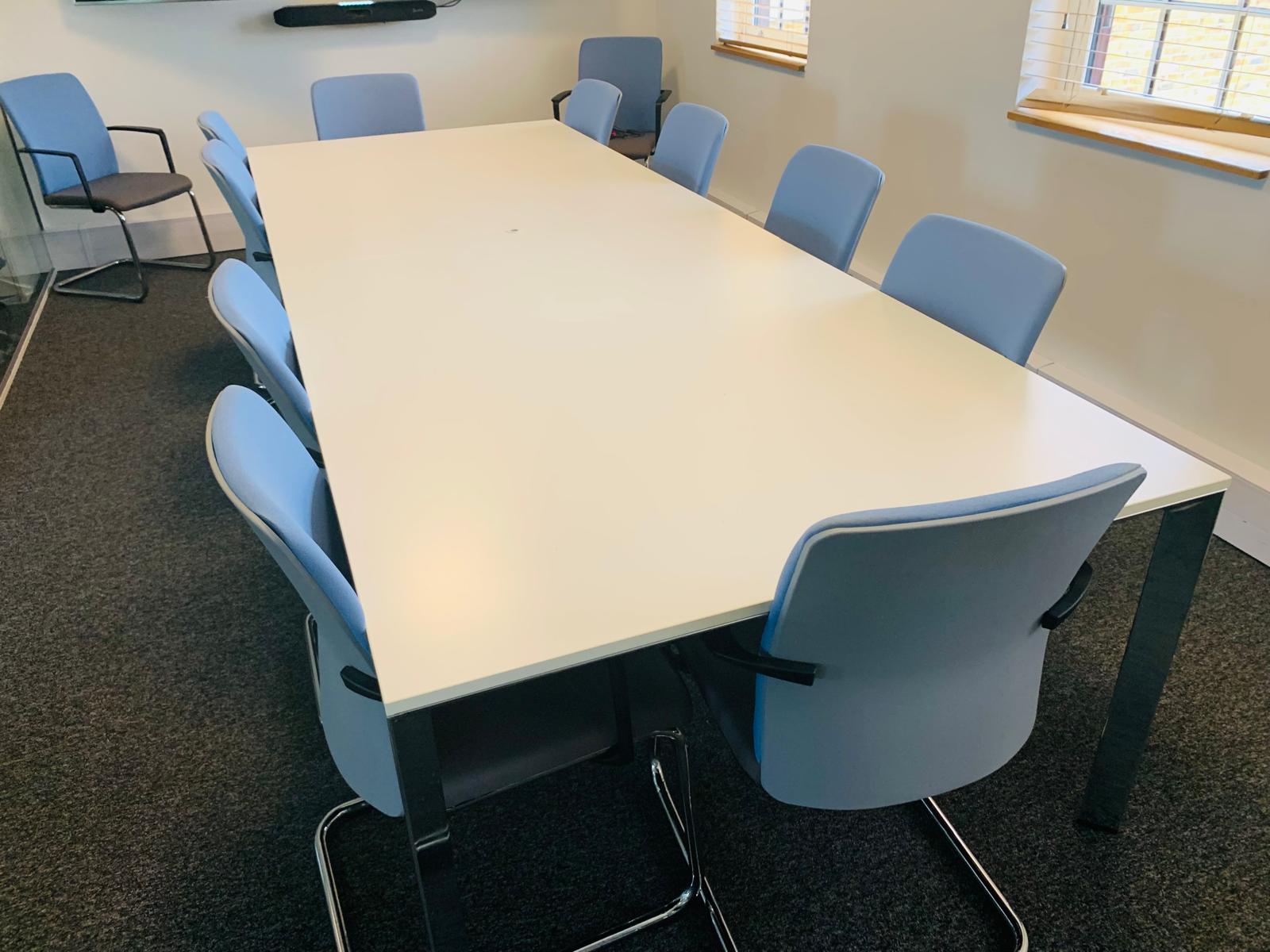 White meeting table and blue padded chairs