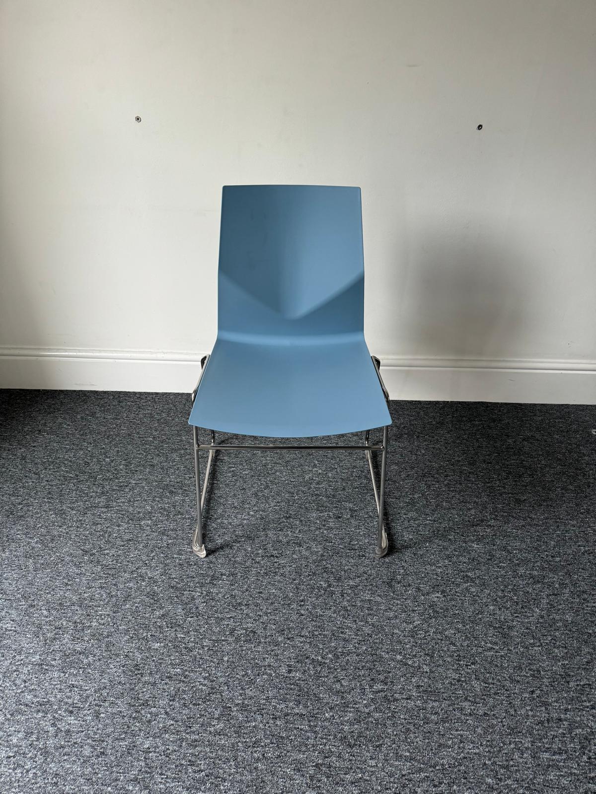 Blue plastic stacking chair