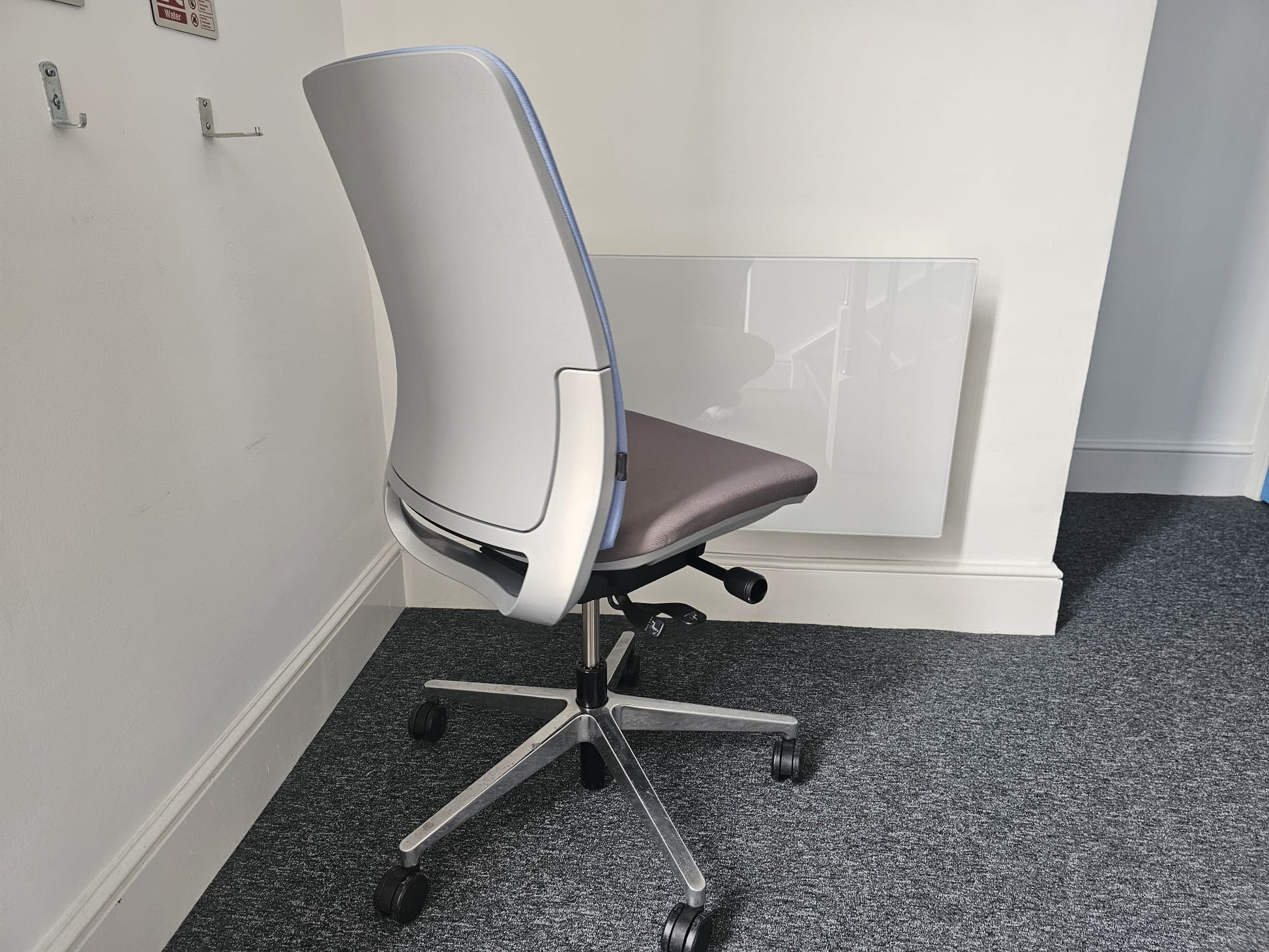 Grey office desk chair on carpet