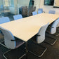 White meeting table and blue chairs in conference room