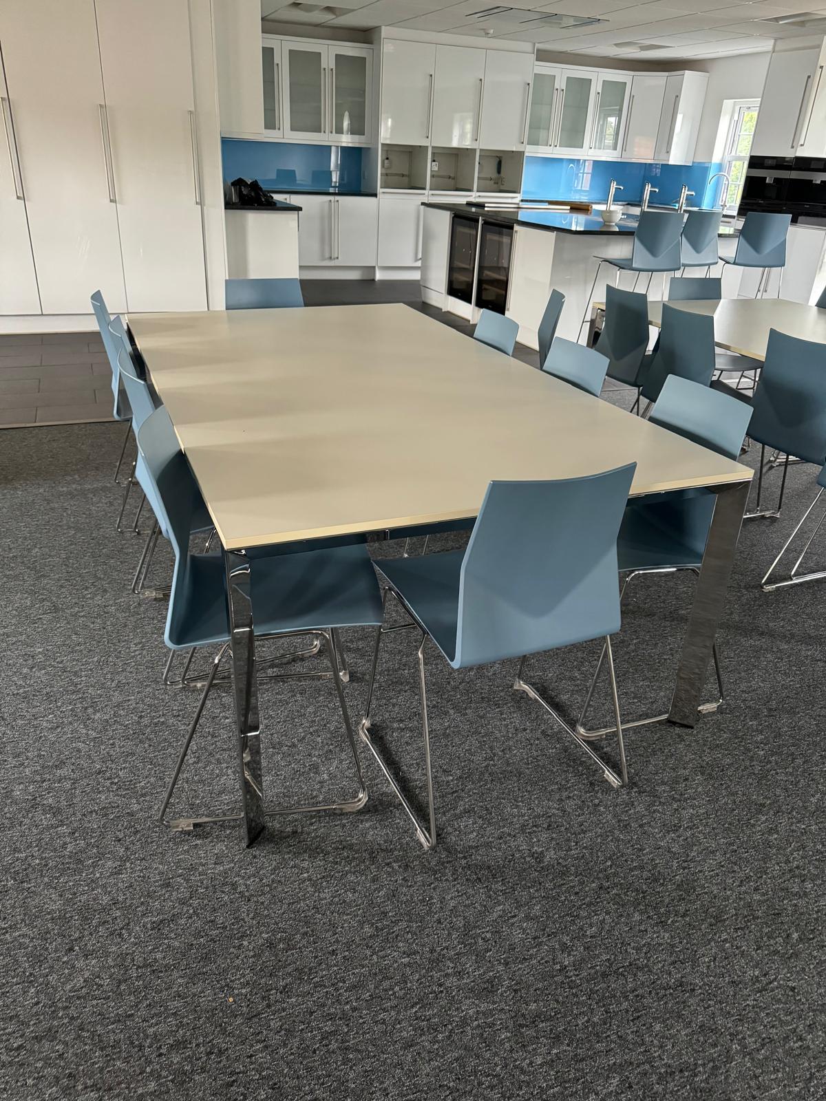 White canteen table and blue plastic chairs