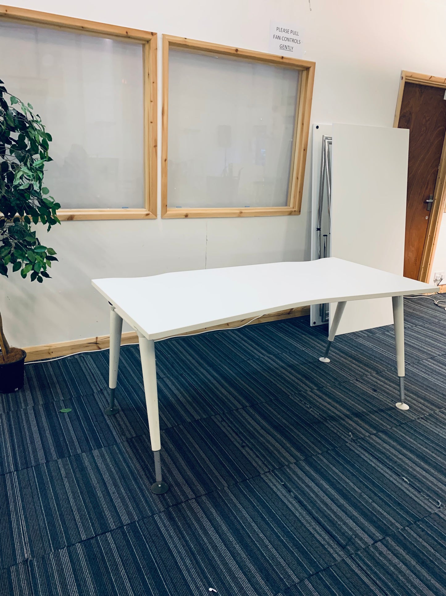 1600mm wide white office desk with green plant and folded tables