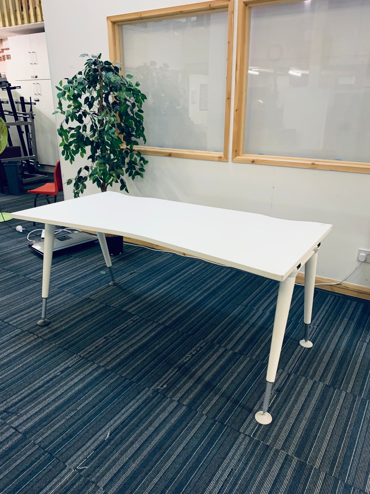 white computer desk in front of office windows