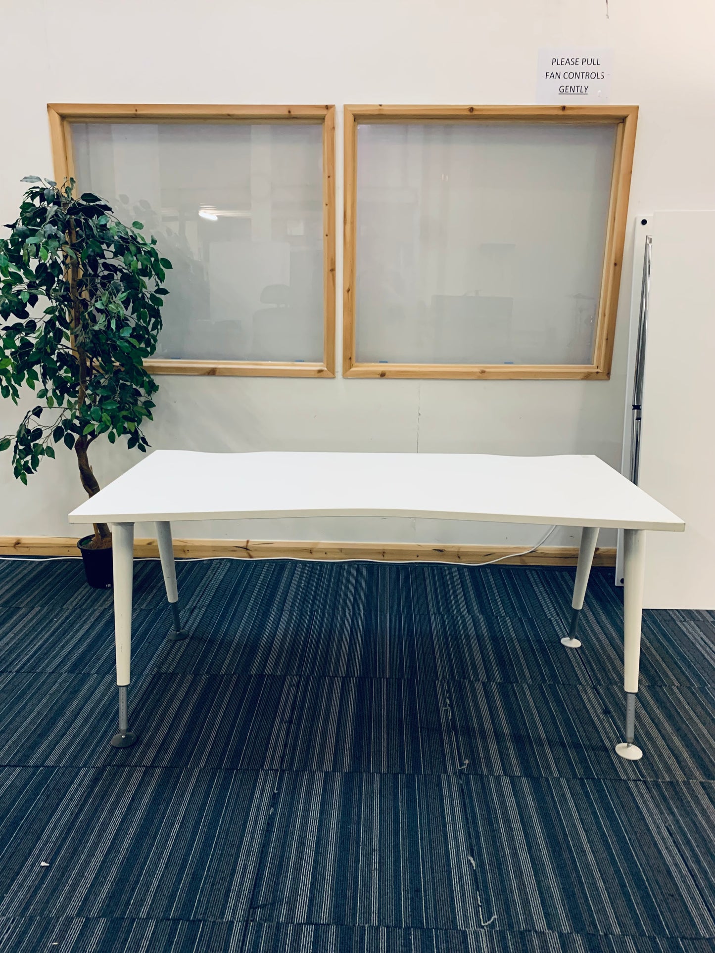 white large office desk on blue carpet