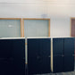 Three lockers under a fan on wall