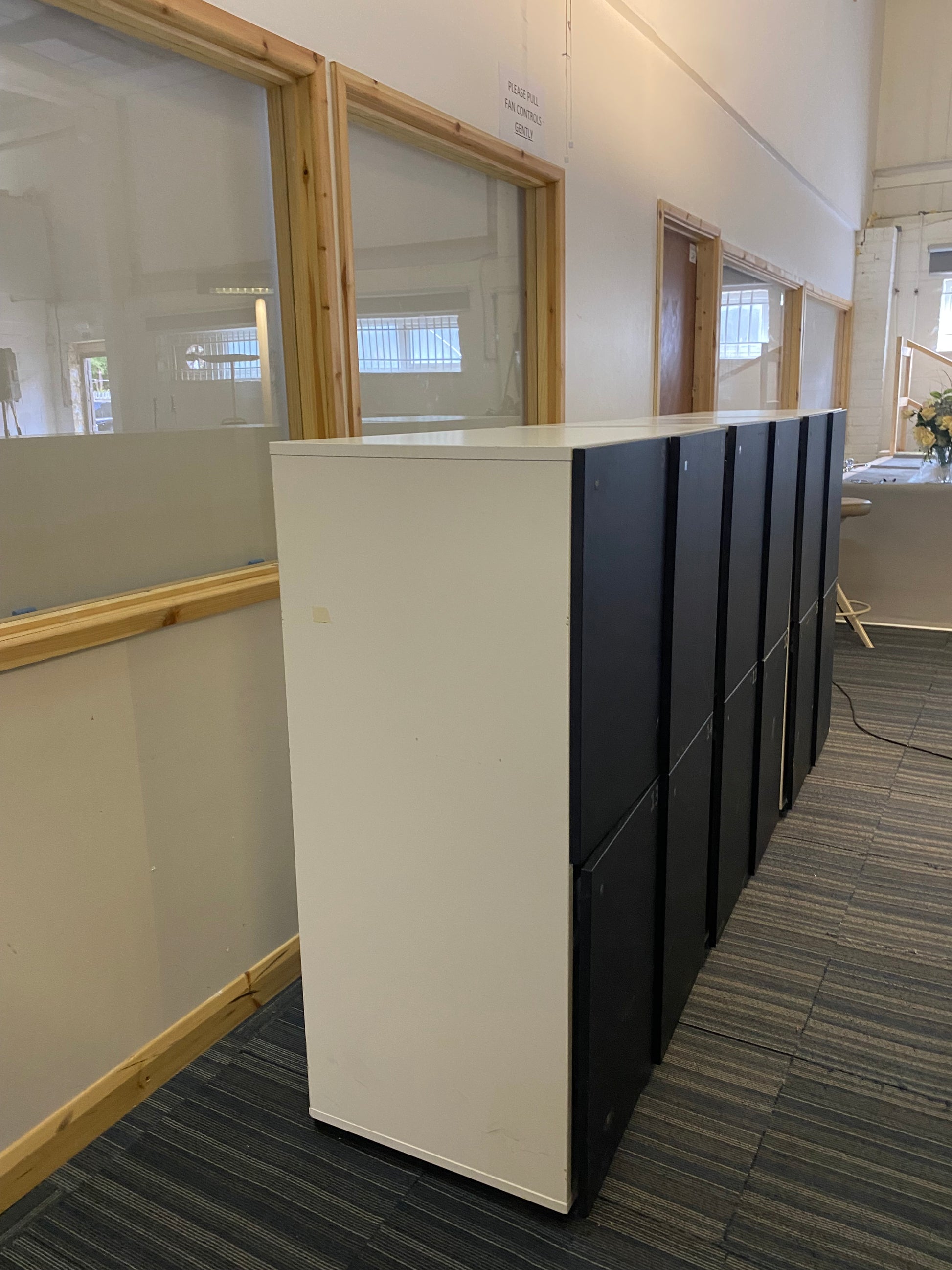 White and black contrast lockers in front of windows