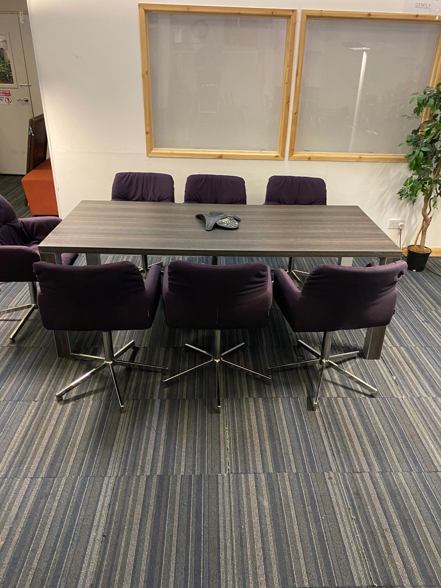 Dark brown table and seven purple chairs