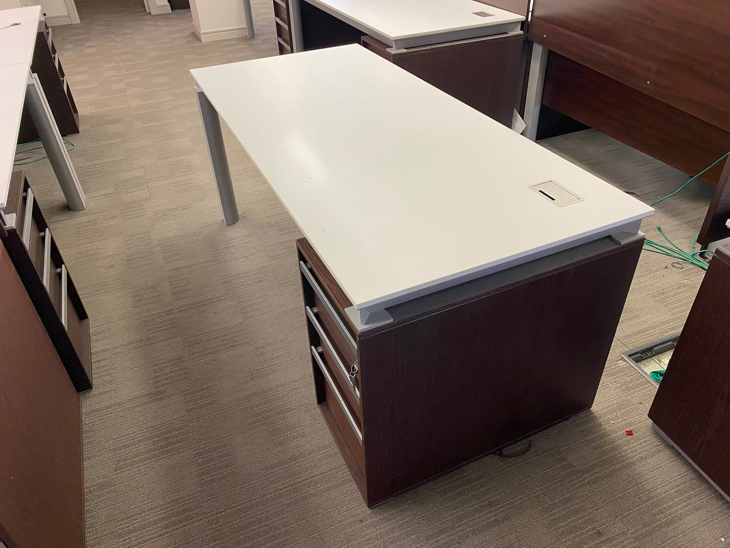 White and walnut executive tables in office
