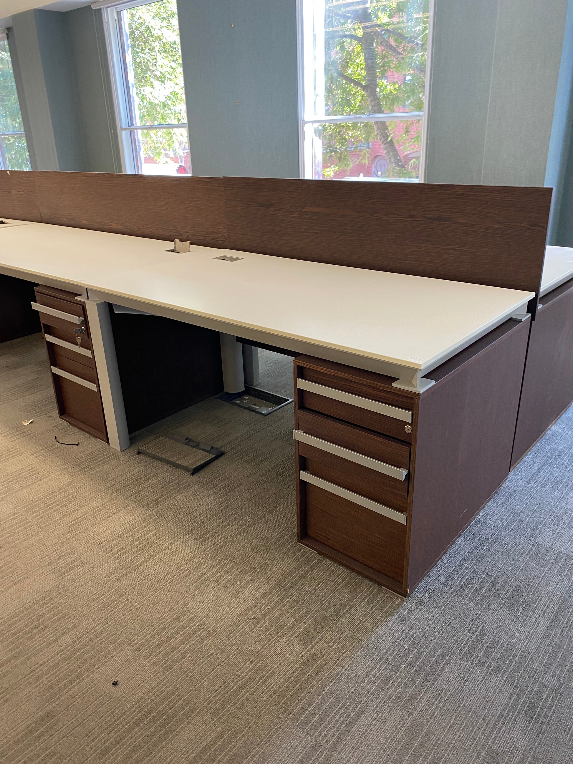 Office desks in a row in walnut and white