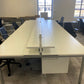 White work bench desk and black chairs