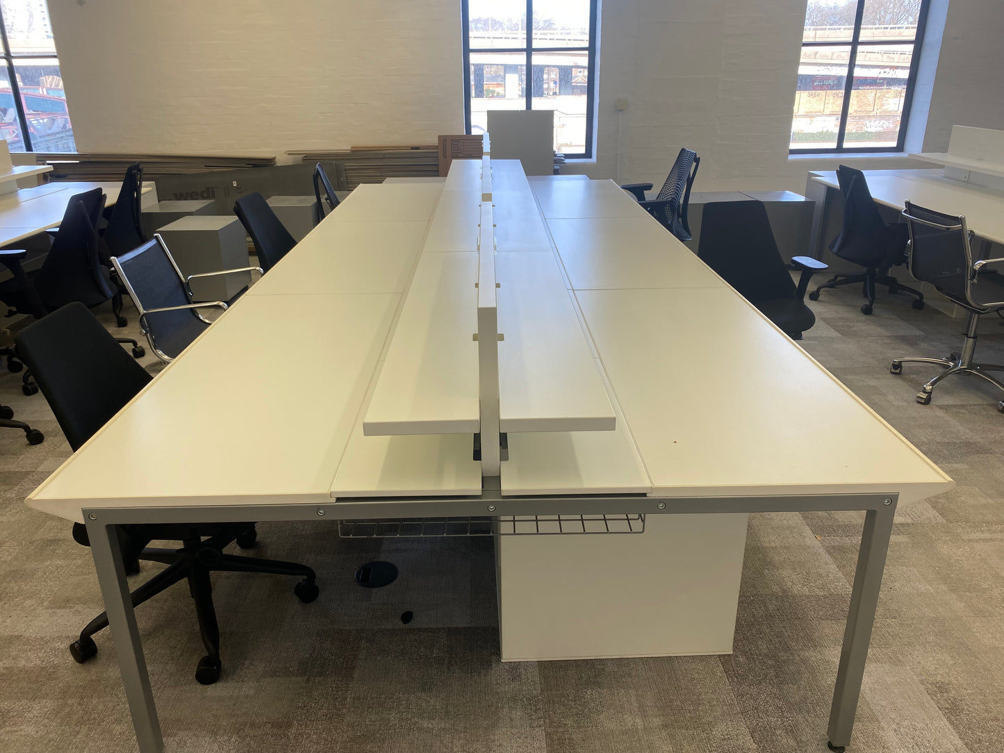 White work bench desk and black chairs