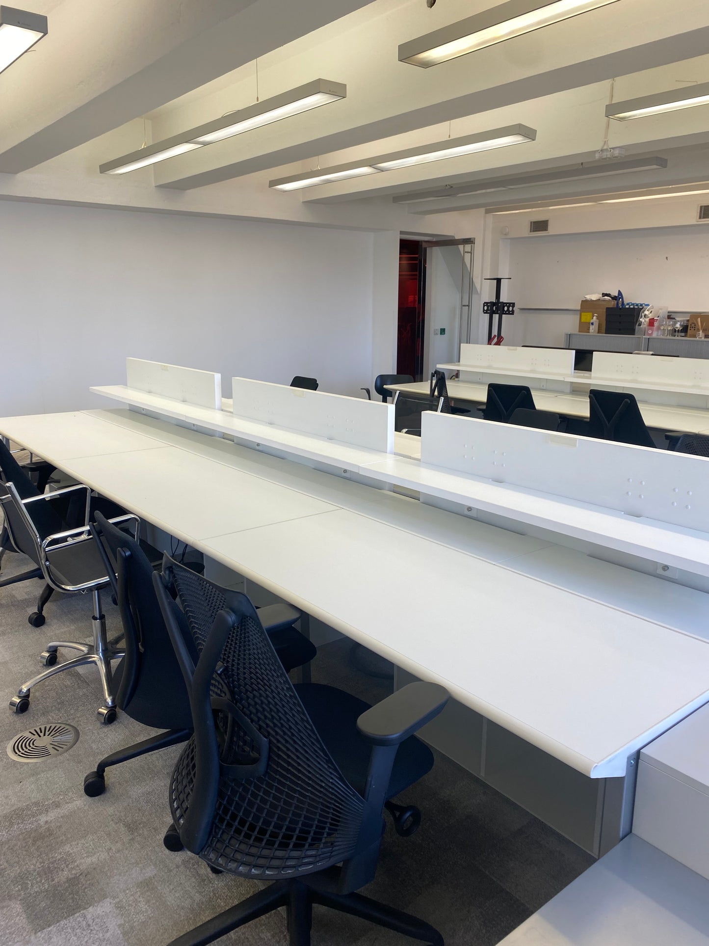 White benching workstations and black chair