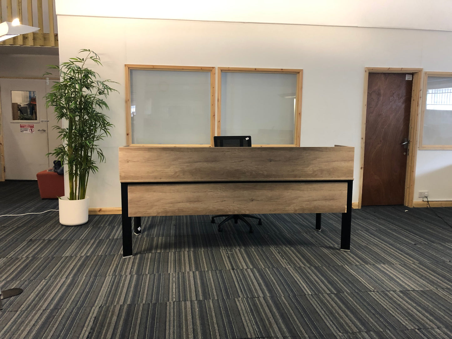 Left, tall green plant, centre, walnut office desk