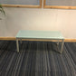 blue glass office reception table centre, top left green tall plant