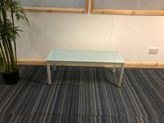 blue glass office reception table centre, top left green tall plant