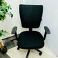 Left, green plant in black vase, centre, black adjustable office chair