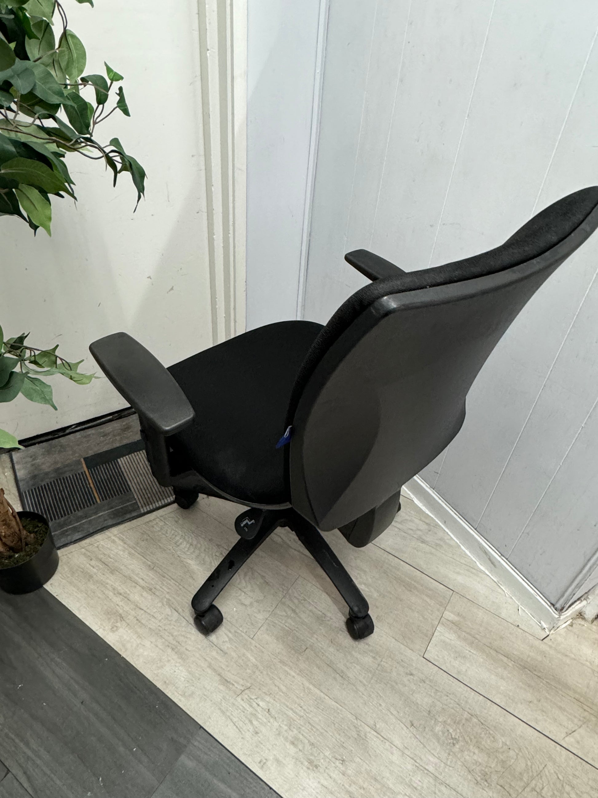 An office chair on wheels in black