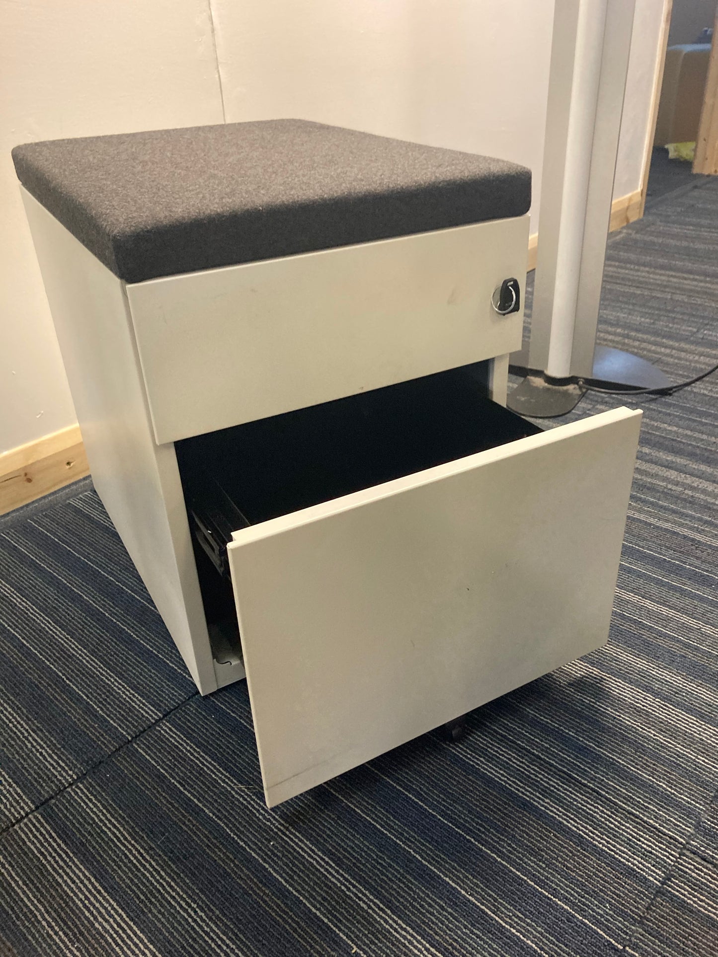 Open bottom drawer on white office drawer