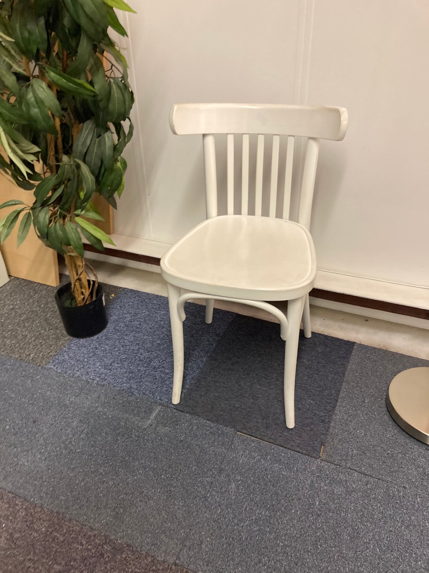 Left, green plant in black vase, centre, white office chair