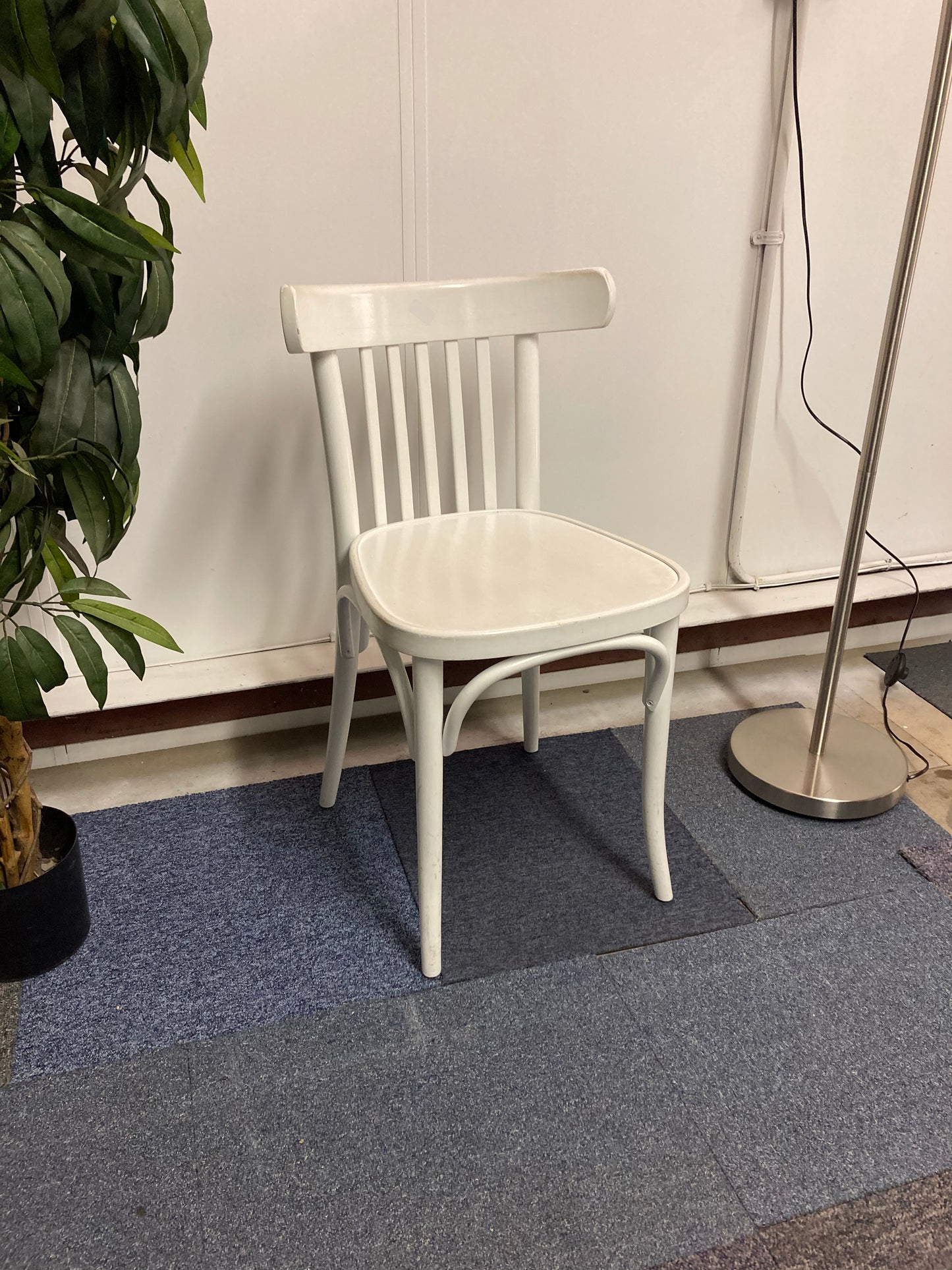 Left, tall green plant, centre, Waiting area char in white