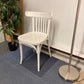 Left, tall green plant, centre, Waiting area chair in white, Right, chrome light stand