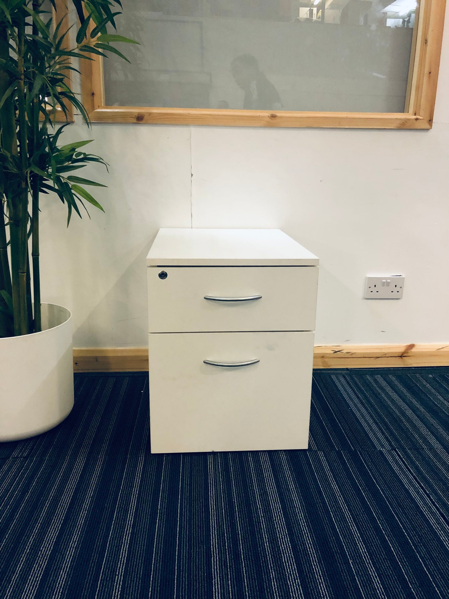 Under drawer cabinet in white on blue carpet