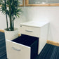 White cabinet with open lower drawer