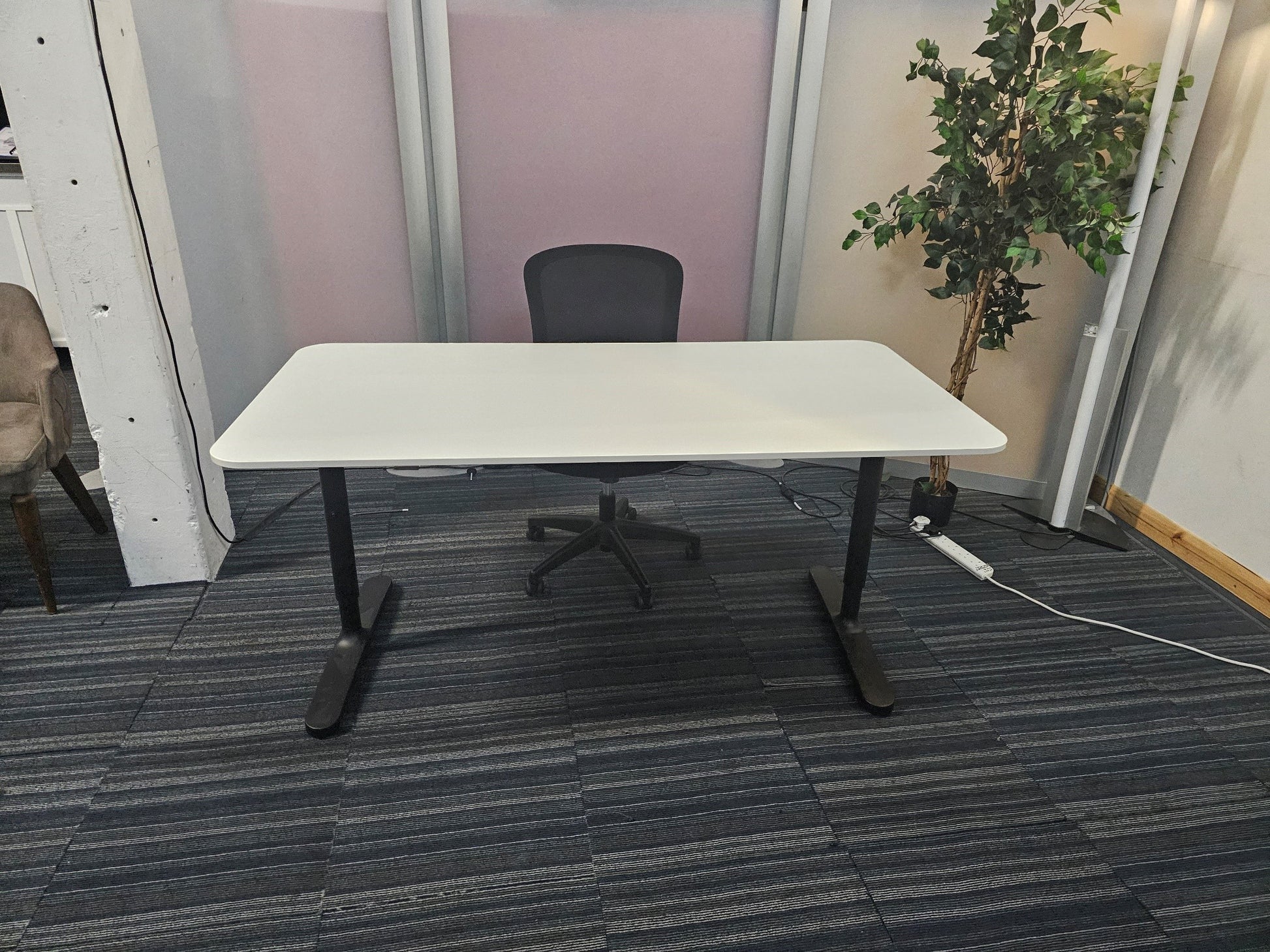 Ikea bekant office desk, with black chair behind