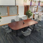 A meeting table in  a large hall six grey chairs encompass