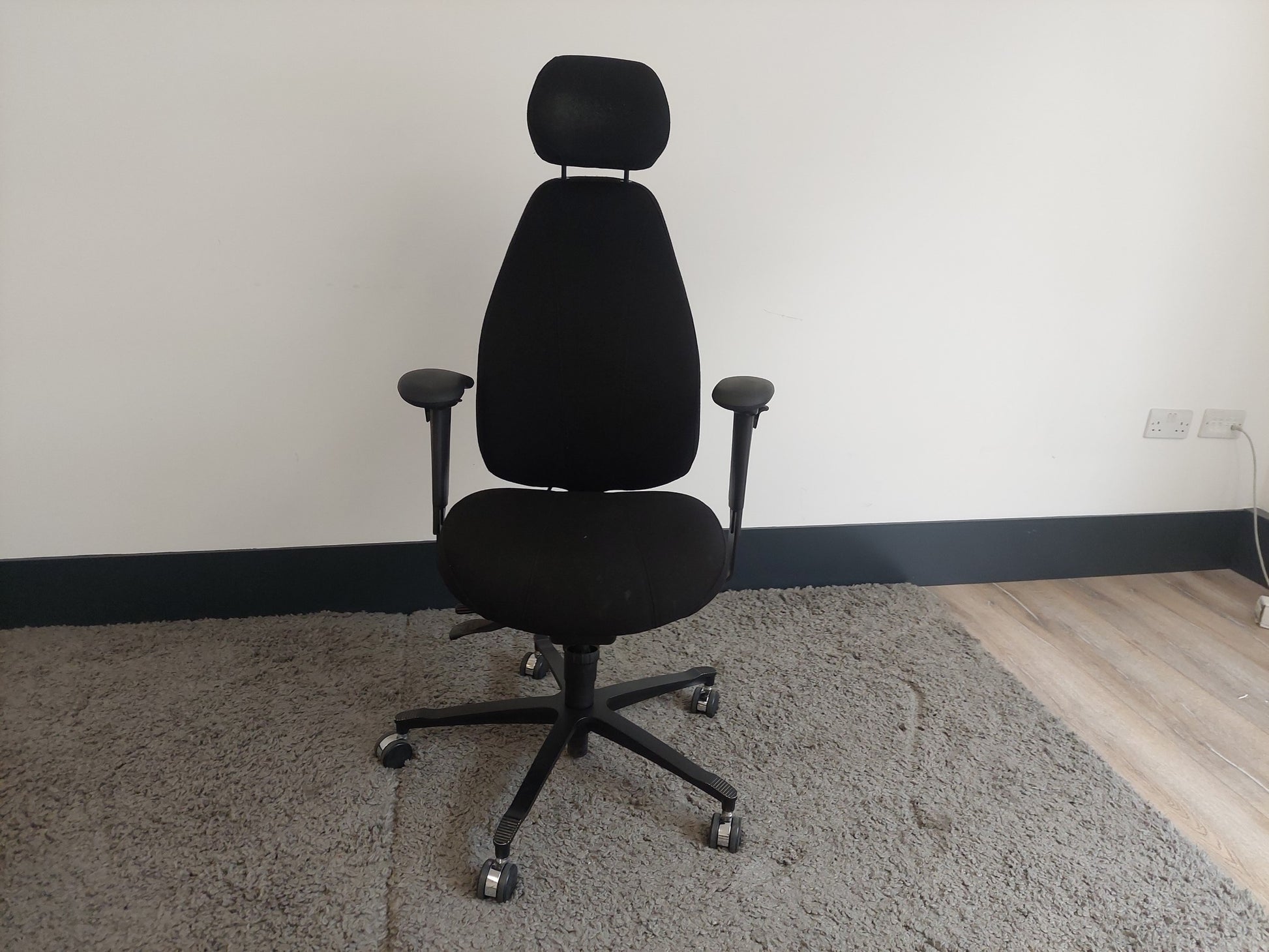 Black swivel desk chair with headrest