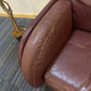damaged arm of leather single armchair sofa with plant