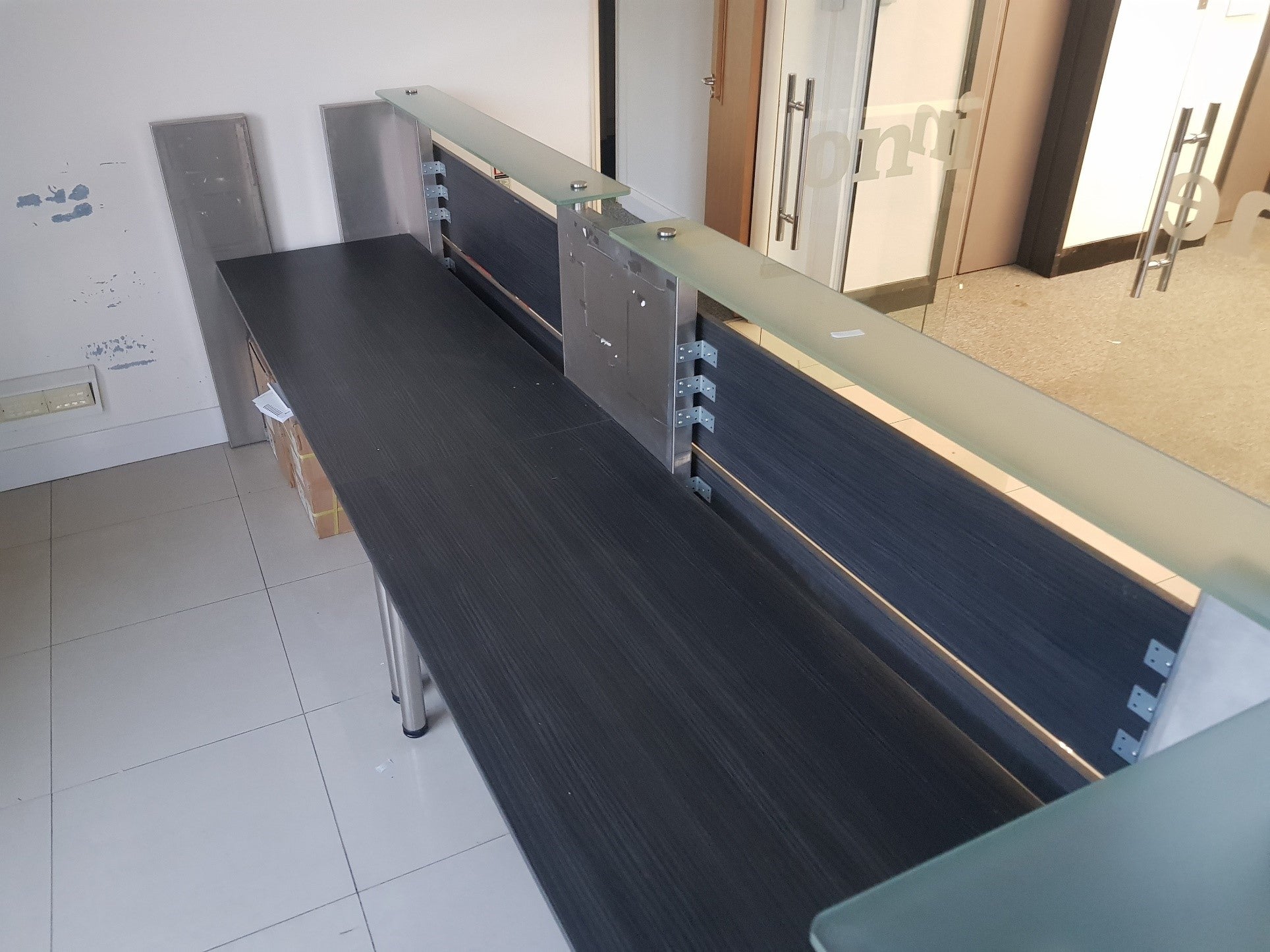 Black and silver glass front reception desk