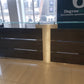 Black and silver reception desk with glass counter