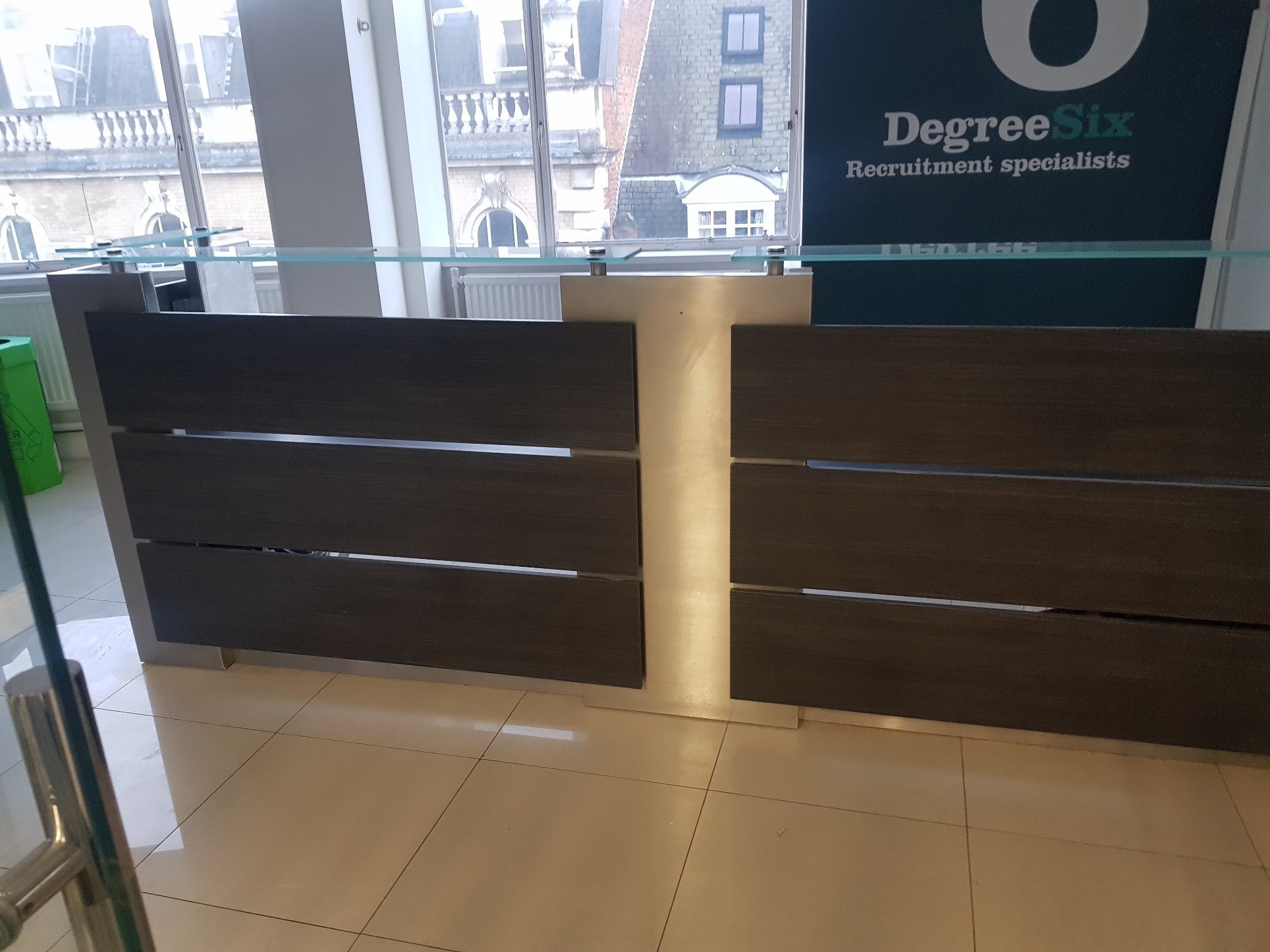 Black and silver reception desk with glass counter