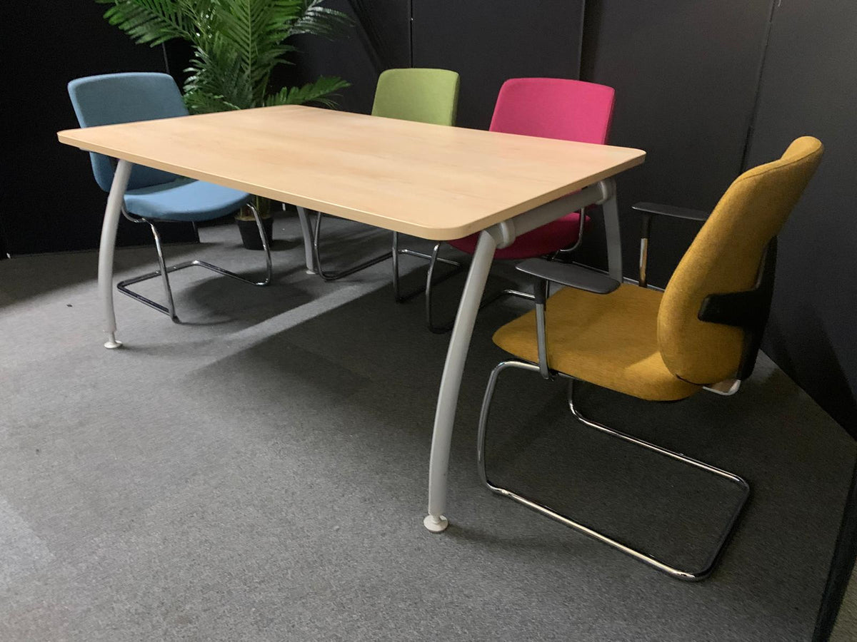 Table with colorful chairs in a room setting