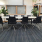 white boardroom table, 2 green plants, 8 meeting chairs