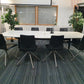 Left, tall green plant, centre, large boardroom table and 8 seats, right, tall green plant