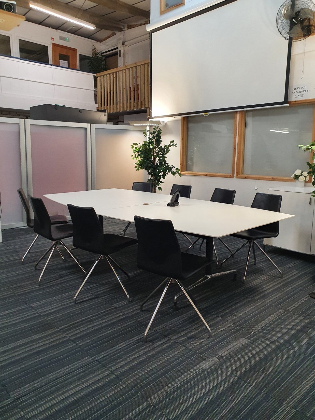 Large Boardroom table in white, with eight black leather meeting chairs