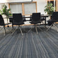 Eight black leather office chairs with stick legs at meeting table