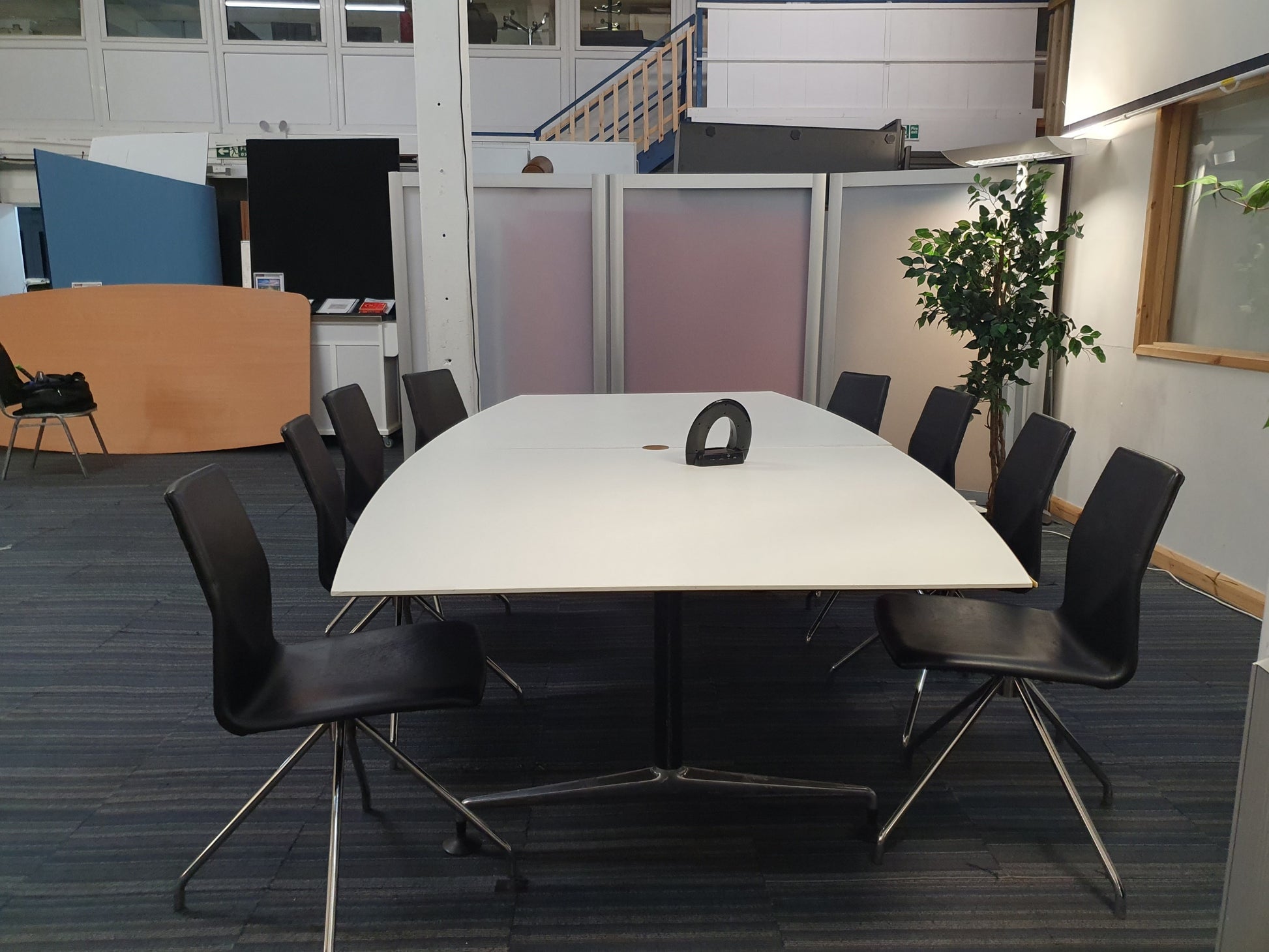 Large training room table and black seats in white