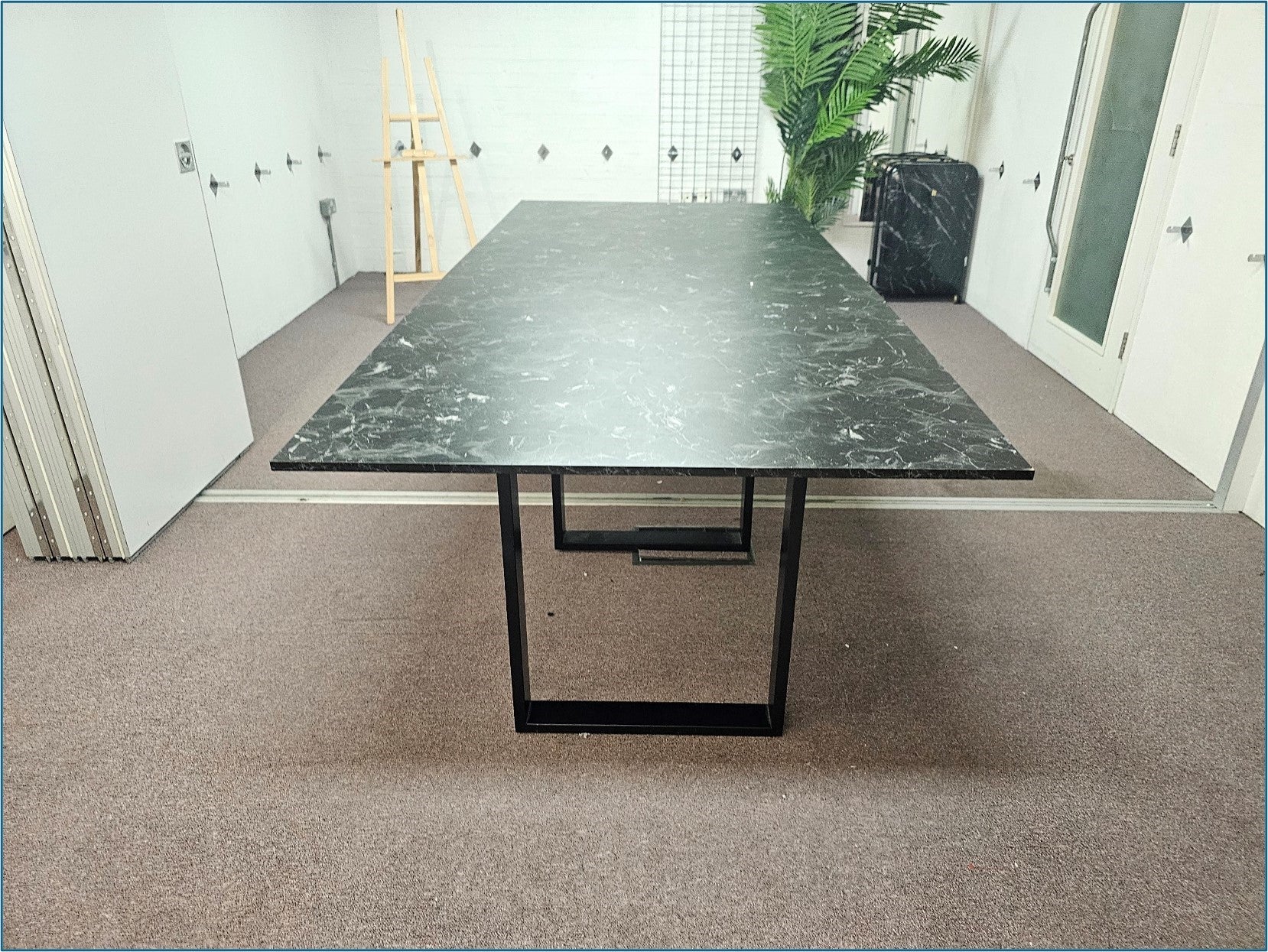 Black marble look tabletop of  long meeting table