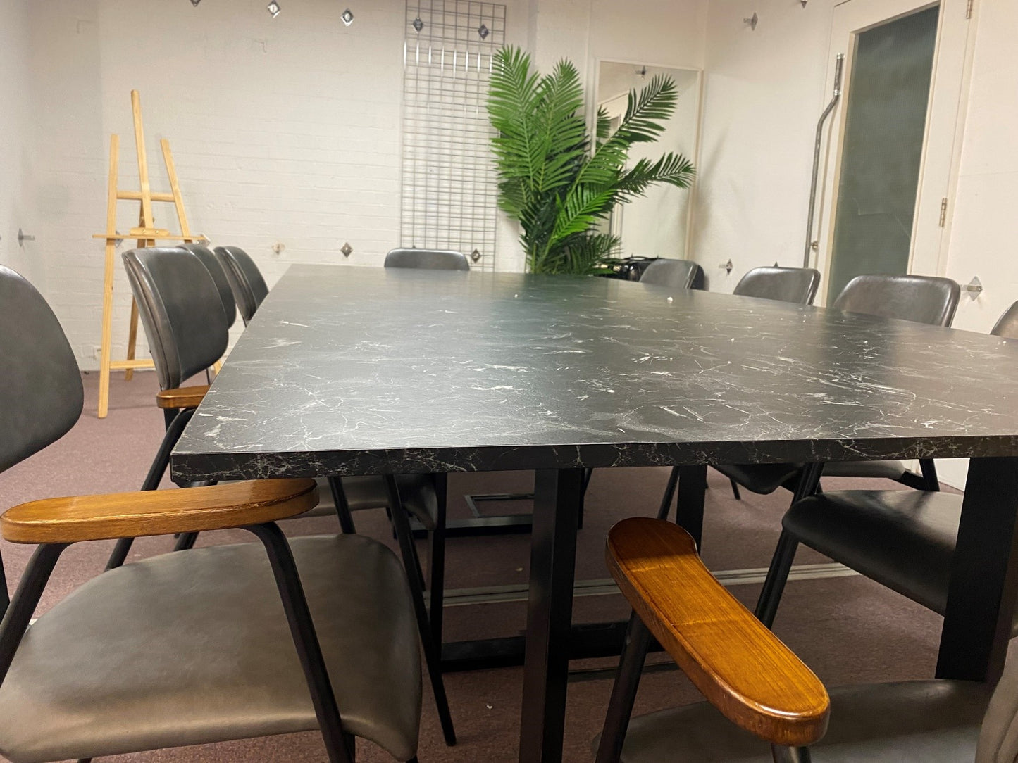 Black marble look tabletop of office meeting table and chairs