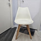 White dining chair with padded seat in front of door