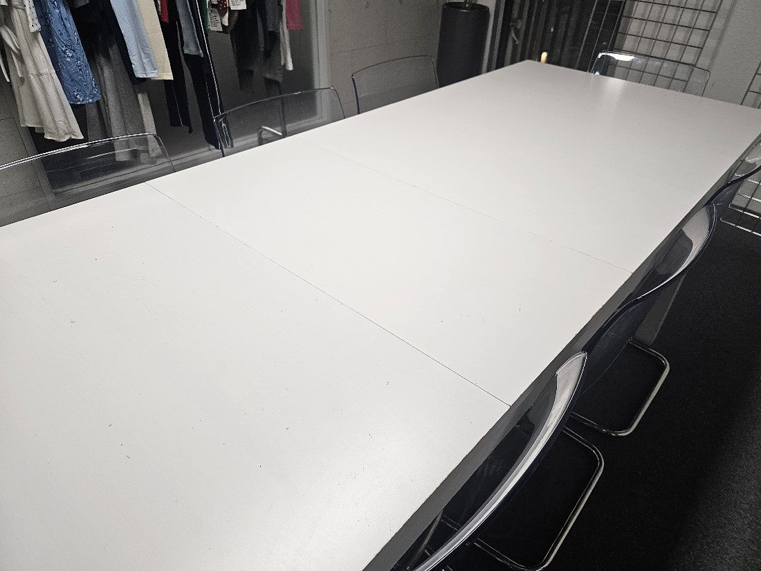 White long eight seater dining table from IKEA with clear perspex chairs