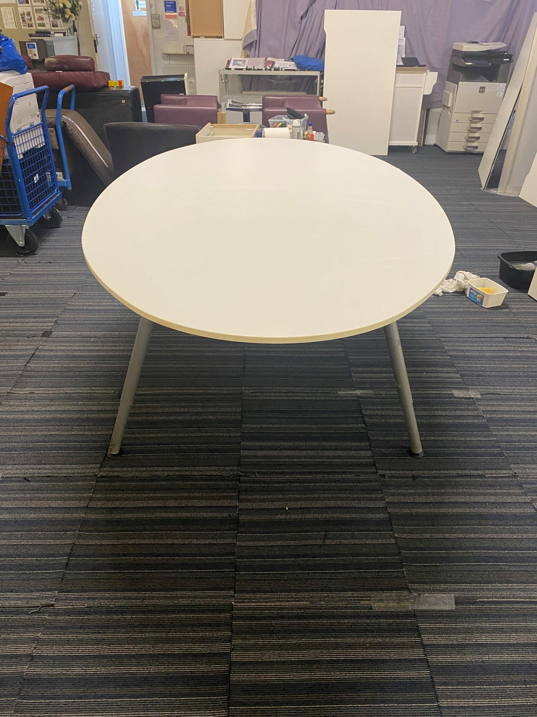 Oval white conference room table in large room